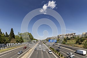 Road traffic in the lanes of the highway in the ring road of Madrid