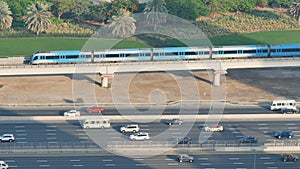 Road traffic with a subway train in the city of Dubai.