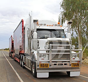 Road train is transporting consumer goods in the Outback, Australia