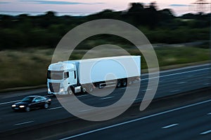 Road transport - white lorry at dusk