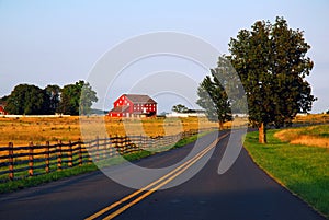 A road traverses bucolic countryside