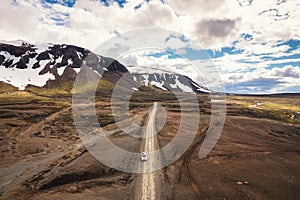 Road trip with 4x4 car on dirt road among remote wilderness on volcanic area in Icelandic highlands on summer at Landmannalaugar,