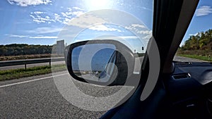 road trip concept driving car by highway rear mirror reflection