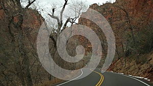 Road trip, driving auto in Zion Canyon, Utah, USA. Hitchhiking traveling in America, autumn journey. Red alien steep