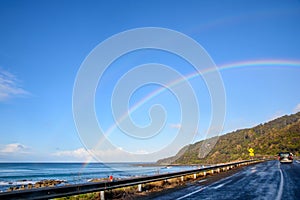 Road trip on Great Ocean Road with rainbow over the sky, Australia