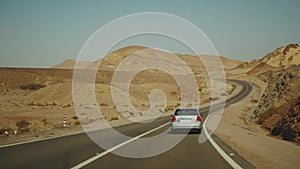 Road trip by highway in desert. Adventure Travel in a desert slow motion.