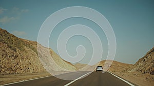 Road trip by highway in desert. Adventure travel in a desert slow motion.