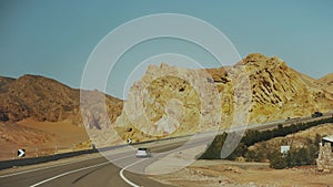 Road trip by highway in desert. Adventure travel in a desert slow motion.