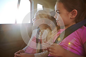 Road trip memories in the making. a two little girls traveling in a car.