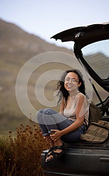 Road trip, portrait and woman on back of car for adventure, summer vacation and holiday. Transport, relax and travel of