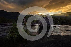 Road trip rest stop Large Boulder in  Otra river Scandinavian landscape at sunrise, Valle Norway photo