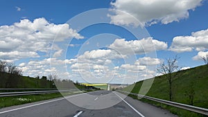 Road trip in the sunny day first-person view of a moving car on a highway natural landscape