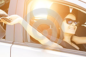 Road trip, teenager girl in summer travel and happy vacation, holidays with friends,woman driver at the wheel in sunglasses