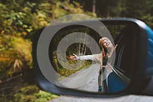 Road trip woman traveling by rental car adventure lifestyle vacation vibes outdoor forest view mirror reflection