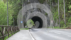 Road with a tunnel in the mountains. Rock tunnels in mountain rural road.