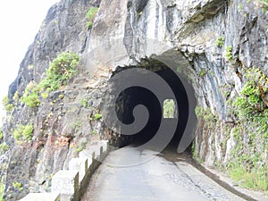Road tunnel through rock cliff