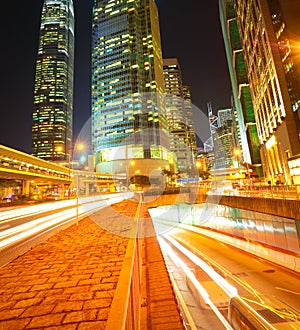 Road tunnels light trails on modern city buildings backgrounds i