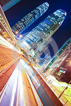 Road tunnels light trails on modern city buildings backgrounds i