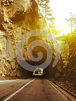 Road through the tunnels in the mountains at sunset