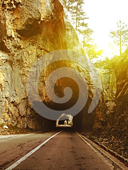 Road through the tunnels in the mountains at sunset photo
