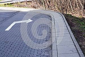 A road turn sign or a drawn marker to nowhere, a turn from the curb. Mismatch of signs and reality, safety at the wheel