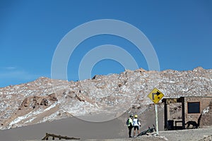 Road turn with yellow road sign in the Atacama desert, Chile