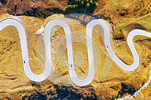 A road with turns through a mountain pass. Aerial landscape. An aerial summer landscape in the Dolomite Alps, Italy.