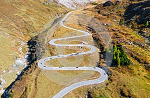 A road with turns through a mountain pass. Aerial landscape. An aerial summer landscape in the Dolomite Alps, Italy.