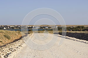 Road under construction. Gravel poured in the steppe as a substrate in front of asphalt