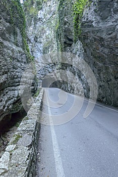 Road under steep ravine at Brasa gorge, Tremosine, Italy photo