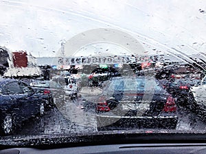 Road view through car window with rain drops, Driving in rain