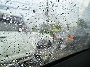 Road view through car windshield with rain drops