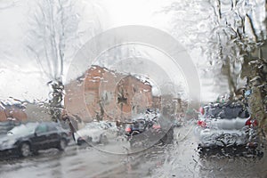 Road view through car windshield with rain drops, Driving in rain