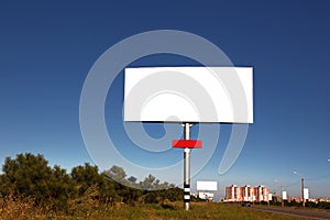 Road in a village with an empty billboard