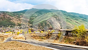 Road and village with high mountain and huge cloud above Thimphu