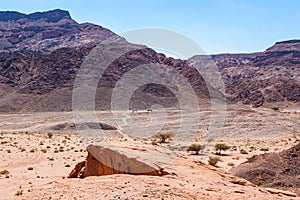 The road, walking path, tracks and trails through yellow red rocky mountains and landscapes of Timna National Park in Negev desert