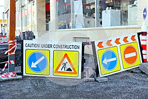 Road warning boards signs with inscriptions caution and under construction.