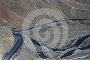 A road winding through barren mountain slopes in Ladakh, India