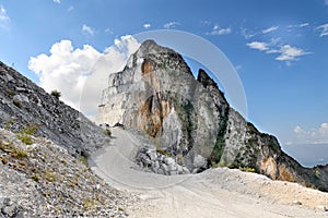 Road winding past an excavated mountain peak