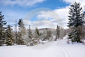 Road in winter mountains rides cars and snow scooters, beautiful blue sky, slovakia beskidy, beskid mountains