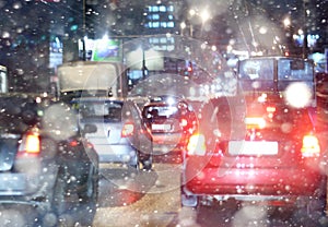 Road in winter night, traffic jams, snow city