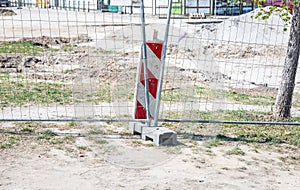 Road work ahead construction site barrier with metal protective fence on the urban street reparation in the city