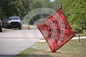 Road work ahead sign on street site as warning to cars about construction and utility works