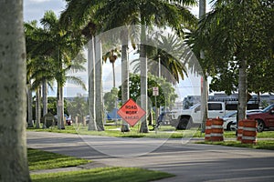 Road work ahead sign on street site as warning to cars about construction and utility works