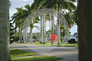 Road work ahead sign on street site as warning to cars about construction and utility works