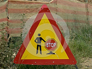 Road work sign under construction.Caution symbol. red an white triangle safety sign warns about roadworks. Careful on highway - co