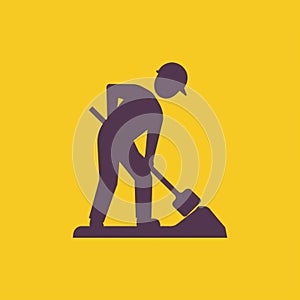 Road worker digging with shovel