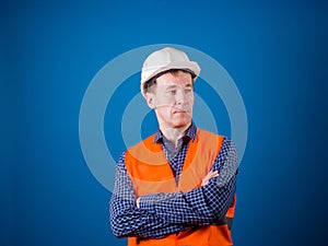 Road worker. A guy in a construction helmet and an orange vest