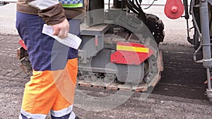 A road worker operator operates a large road cold milling machine