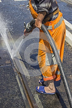 Road worker wearing slippers and using water jet 2 photo